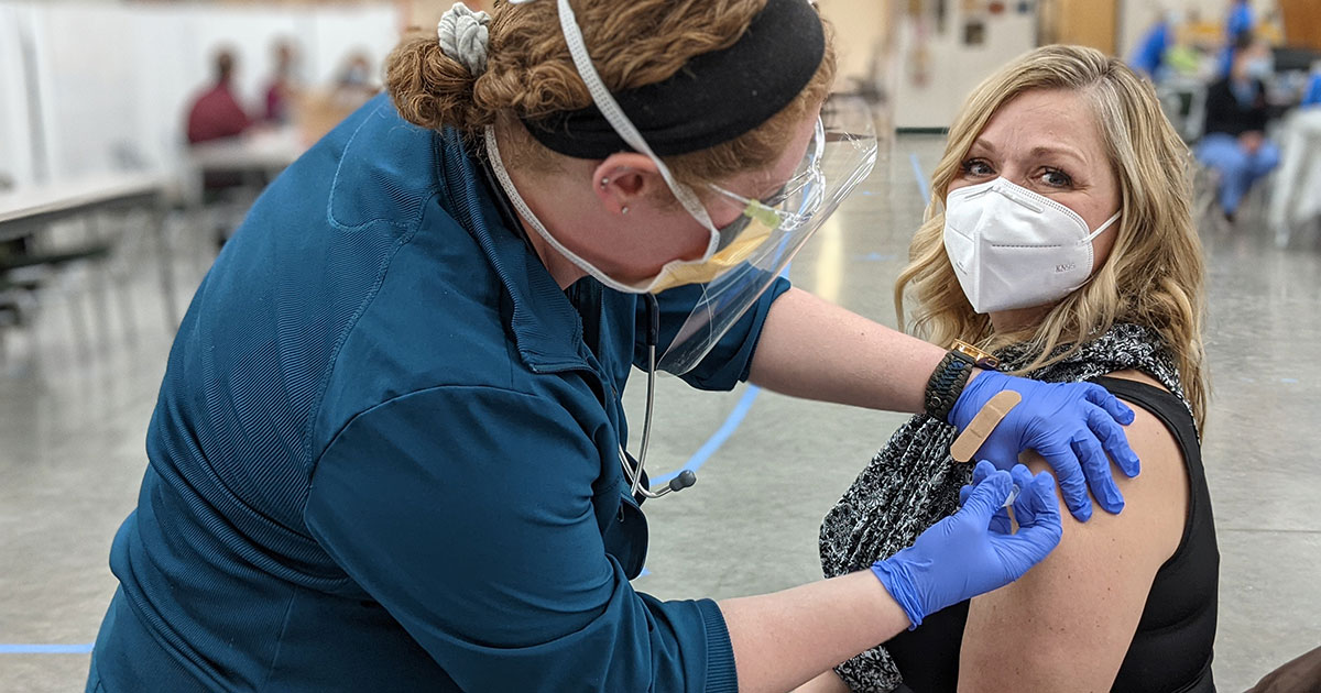 Anoka-Ramsey Nursing student administering the Moderna COVID-19 vaccine