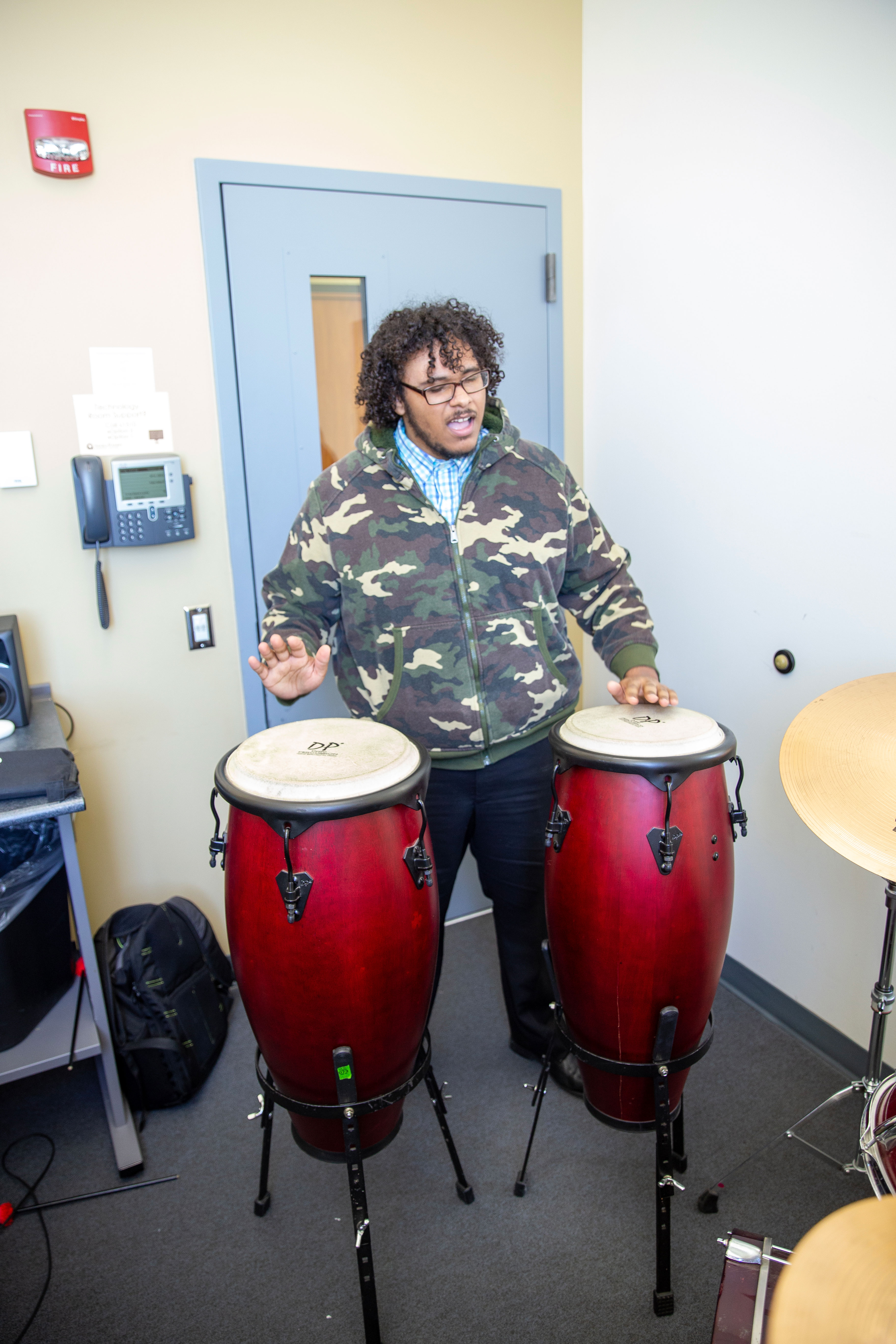 Student playing congas